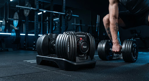 Adjustable dumbbells in a professional gym setting